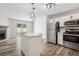 Updated kitchen with stainless steel appliances, center island, and modern lighting fixtures at 1707 Ostia Cir # 46, Lafayette, CO 80026