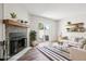 Bright living room features a stone fireplace, wood mantle and sliding door access to the outside at 1707 Ostia Cir # 46, Lafayette, CO 80026