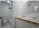Bright bathroom with double sinks, and a shower/tub with a shower curtain at 655 N Pearl St # 208, Denver, CO 80203