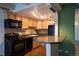 Well-lit kitchen featuring wooden cabinets, modern appliances, and a convenient breakfast bar at 655 N Pearl St # 208, Denver, CO 80203