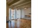 Bright living room with hardwood floors, ceiling fan, and sliding doors to a private balcony at 655 N Pearl St # 208, Denver, CO 80203