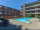 Apartment buildings overlook a refreshing community pool with ample space for lounging at 655 N Pearl St # 208, Denver, CO 80203
