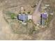 Overhead view of house, detached buildings and large lot at 8441 Flint Ridge St, Bennett, CO 80102