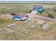 Aerial view of property showing home, outbuildings, and surrounding fields at 8441 Flint Ridge St, Bennett, CO 80102