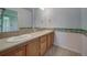 Bathroom with double sinks and playful border at 8441 Flint Ridge St, Bennett, CO 80102