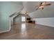 Large bonus room with wood flooring and ceiling fan at 8441 Flint Ridge St, Bennett, CO 80102