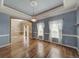 Hardwood floors, light blue walls, and a view of the entryway at 8441 Flint Ridge St, Bennett, CO 80102
