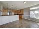 Kitchen with wood cabinets, stainless steel appliances, and tile floor at 8441 Flint Ridge St, Bennett, CO 80102