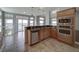 Kitchen features stainless steel appliances and views to backyard at 8441 Flint Ridge St, Bennett, CO 80102