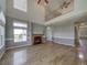 Large living room with hardwood floors, fireplace and high ceilings at 8441 Flint Ridge St, Bennett, CO 80102