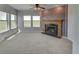 Spacious living room featuring a fireplace and large windows at 8441 Flint Ridge St, Bennett, CO 80102