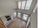 Open living room with hardwood floors and large windows at 8441 Flint Ridge St, Bennett, CO 80102