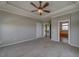 Large main bedroom with ceiling fan and en-suite bathroom at 8441 Flint Ridge St, Bennett, CO 80102