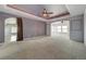 Main bedroom with high ceilings, carpet, and ceiling fan at 8441 Flint Ridge St, Bennett, CO 80102