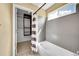 Neat bathroom featuring a tub with modern grey honeycomb tiles and a striped shower curtain at 17826 E Cloudberry Dr, Parker, CO 80134