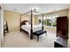 Spacious bedroom featuring a four-poster bed, natural light, and ample space for relaxing and decor at 17826 E Cloudberry Dr, Parker, CO 80134