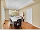 Formal dining room bathed in sunlight, complemented by an elegant table and decor at 17826 E Cloudberry Dr, Parker, CO 80134