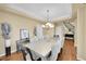 Elegant dining room with tray ceiling, modern chandelier, and a sophisticated color palette at 17826 E Cloudberry Dr, Parker, CO 80134