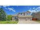 Charming two-story home with a well-manicured lawn and a three car garage at 17826 E Cloudberry Dr, Parker, CO 80134