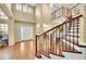 Gorgeous foyer with soaring ceilings, wood floors, and a winding staircase at 17826 E Cloudberry Dr, Parker, CO 80134