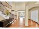 Inviting foyer with wood floors, grand staircase, and natural light at 17826 E Cloudberry Dr, Parker, CO 80134