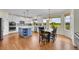 Open kitchen with island and eat-in dining area offers lots of natural light and space at 17826 E Cloudberry Dr, Parker, CO 80134