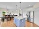 Open kitchen and dining area with stainless steel refrigerator and view to the living room at 17826 E Cloudberry Dr, Parker, CO 80134