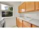 Laundry room featuring storage cabinets, a sink, and a window at 17826 E Cloudberry Dr, Parker, CO 80134