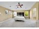 Bright main bedroom featuring a ceiling fan, three windows, and an en suite bathroom at 17826 E Cloudberry Dr, Parker, CO 80134