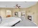 Spacious bedroom featuring a ceiling fan, fireplace, and access to an en suite bathroom at 17826 E Cloudberry Dr, Parker, CO 80134