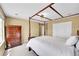 Charming main bedroom featuring a four-poster bed, ample storage, and plenty of natural light at 17826 E Cloudberry Dr, Parker, CO 80134