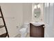 Well-lit powder room with stylish vanity, modern fixtures, and decorative ladder shelf for storage at 17826 E Cloudberry Dr, Parker, CO 80134