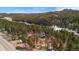 A captivating aerial perspective of the property with a home surrounded by a dense forest at 27231 Log Trl, Conifer, CO 80433