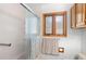 Bright bathroom with shower stall and framed window with built in cabinet for storage at 27231 Log Trl, Conifer, CO 80433