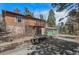 A charming exterior view showcasing a stone-clad house with a spacious three-car garage at 27231 Log Trl, Conifer, CO 80433