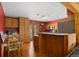 Bright kitchen with wooden cabinetry, a breakfast bar, stainless steel appliances, and a cozy dining area at 27231 Log Trl, Conifer, CO 80433