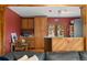 Cozy kitchen with warm wood cabinetry, modern appliances, and a breakfast bar for casual dining at 27231 Log Trl, Conifer, CO 80433