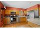 Well-equipped kitchen with stainless steel appliances, wood cabinets, a breakfast bar, and ample counter space at 27231 Log Trl, Conifer, CO 80433