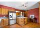 This kitchen has lots of storage, stainless steel refrigerator, and island for additional seating at 27231 Log Trl, Conifer, CO 80433