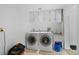 Well-lit laundry room featuring built-in cabinets, washer, dryer, utility sink, and vinyl flooring at 27231 Log Trl, Conifer, CO 80433