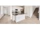 Open kitchen featuring white cabinets, stainless steel appliances, and an island at 537 Nightsky St, Erie, CO 80516