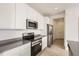 Modern kitchen with stainless steel appliances and white cabinetry at 537 Nightsky St, Erie, CO 80516