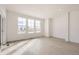 Bright, empty living room with hardwood floors and large windows at 537 Nightsky St, Erie, CO 80516