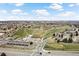 Picturesque aerial view of community amenities, including a golf course, pond, and well-maintained green spaces at 7770 W 87Th Dr # F, Arvada, CO 80005