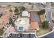 Aerial shot of community amenities: pool, tennis court, clubhouse and parking among residences at 7770 W 87Th Dr # F, Arvada, CO 80005