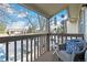 Cozy balcony with wicker chair, blue cushions, and neighborhood views at 7770 W 87Th Dr # F, Arvada, CO 80005