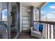 Cozy balcony featuring a comfortable chair, shelving for storage, and views of the surrounding landscape at 7770 W 87Th Dr # F, Arvada, CO 80005