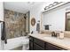 Updated bathroom with modern vanity, decorative mirror, and tiled shower at 7770 W 87Th Dr # F, Arvada, CO 80005