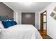 Elegant bedroom showcasing hardwood floors, accent wall, and a closet, providing style and functionality at 7770 W 87Th Dr # F, Arvada, CO 80005