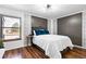Comfortable bedroom with hardwood floors, neutral paint colors, and a window that provides natural light at 7770 W 87Th Dr # F, Arvada, CO 80005